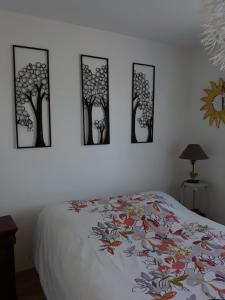 1 dormitorio con 4 fotos de árboles en la pared en Chez isa, en Massilly