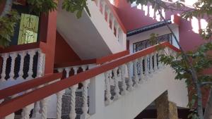 a building with a white and red stair railing at Hotel Ain Leuh in Aïn Leuh