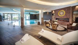 a living room with a swimming pool and a fireplace at Hotel Miramonti in Bagno di Romagna