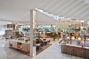 Una representación de una biblioteca con mesas y sillas. en Meliá Palma Marina, en Palma de Mallorca