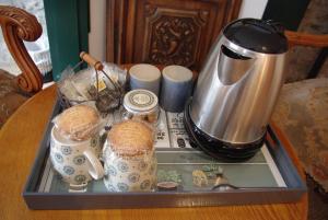 a tray with a tea kettle on top of a table at Ti Ar Bugale in Huelgoat
