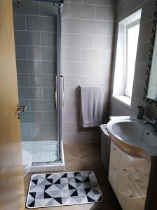 ein Badezimmer mit Dusche und Waschbecken in der Unterkunft Casa dos avós in Alvor