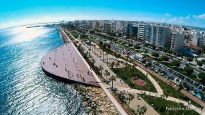 an aerial view of a city next to the ocean at Kermia Court - Beach-front, modern 2 bedroom -sleeps 6 in Limassol