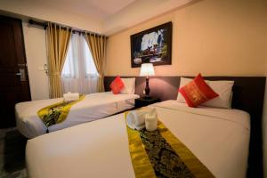 a hotel room with two beds and a window at Panna Heritage Boutique Hotel - SHA Plus in Chiang Mai