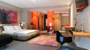a hotel room with a bed and a desk at 101 Adrianou Apartments in Athens