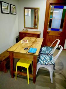 a wooden table with two chairs and a mirror at The Homestead in Taupo +25 photos