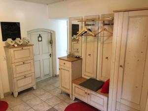 a room with wooden cabinets and a desk in a room at Anita's Zimmer in Engelhartszell