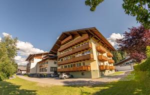 a building with a car parked in front of it at Powderia Family & Freelance Apartment in the center of Ski Amadé in Altenmarkt im Pongau