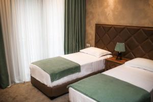 Postel nebo postele na pokoji v ubytování Boutique Hotel Mimino