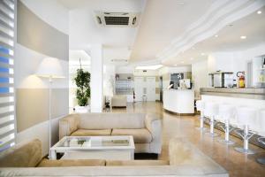 a living room with a couch and a table at Hotel Aqua in Cattolica
