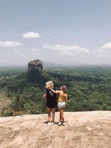 two women standing on the top of a mountain at Sanctuary Cove Guest House in Polonnaruwa
