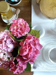 un ramo de flores rosas sentado en una mesa en Piccola Corte Antica, en Corticelle Pieve