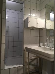 a bathroom with a sink and a shower with a mirror at La Calade, maison de village in Gordes +36 photos