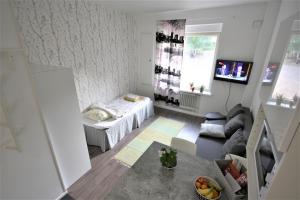 mały salon z łóżkiem i kanapą w obiekcie City Centre Apartment Puistokatu 29 w mieście Jyväskylä