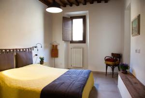 a bedroom with a bed with a yellow blanket at A casa tua - Apartment in Florence in Scandicci