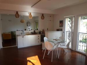a kitchen with a table and chairs in a room at Bright Central Apartman in Tivat