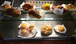 a display case filled with different types of pastries at B&B PORTA APPIA in Imola