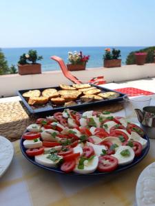 a plate of food with tomatoes and other foods on a table at Villa Mimmi in Lido Di Fondi +22 photos