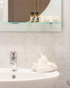 a bathroom with a sink with a towel on it at Christianna Studios in Nikiana