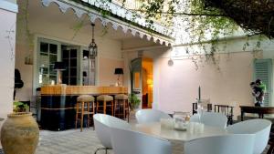 a dining room with a table and chairs and a bar at Les Chapeliers in Claviers