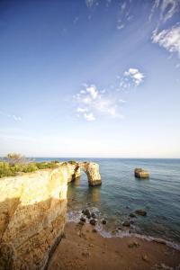two large rocks in the ocean next to the shore at Vila Alba Resort in Carvoeiro