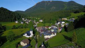 an aerial view of a village in the mountains at Gasthof Kirchenwirt in Lackenhof