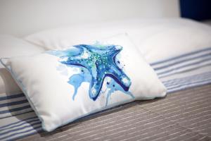 a pillow with a starfish on it on a bed at La Casa del Vento in La Spezia