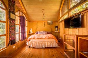 a bedroom in a tree house with a bed in it at Lake Front Cabin in Santa Cruz La Laguna