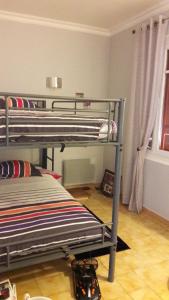 a bedroom with two bunk beds in a room at Bordl'o in Aurec-sur-Loire