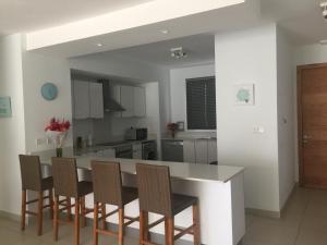 a kitchen with a table and chairs at Element Bay Lux Beach Apartment in Cap Malheureux