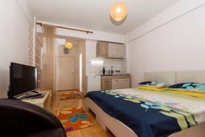 een slaapkamer met een groot bed en een keuken bij Etaksimo Central Apartment in Ohrid
