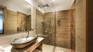 a bathroom with a large tub and a shower at Sporthotel Romantic Plaza in Madonna di Campiglio +73 photos