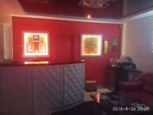 a red room with a bar and a red wall at ApartHotel Dom in Odesa