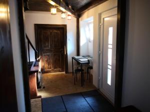 a hallway with a door and a desk in a room at Bus Station Beds in Bled