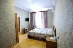 a hotel room with a bed and a window at Canyon Hotel in Martvili +41 photos