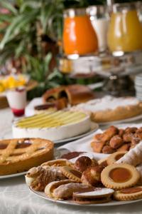 a table filled with different types of bread and pastries at Locanda al Castello Wellness Resort in Cividale del Friuli