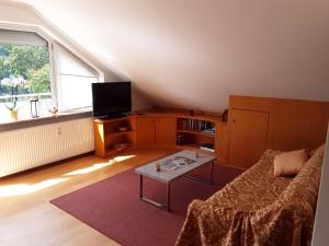 a living room with a couch and a table at Stürmlesloch in Bad Wildbad