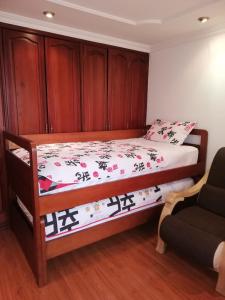 a bedroom with a bed with a wooden headboard at D'lujo in Bogotá