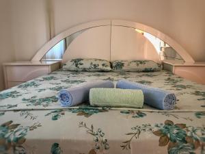 a bed with two pillows on top of it at Eleni Apartments in Gevgelija