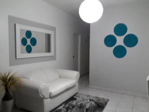 a white living room with a white couch and a painting at Isla Verde Apt Two-Bedroom in San Juan