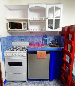 a toy kitchen with a stove and a sink at Rositas Hotel in San Juan del Sur