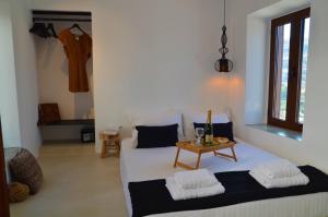 a room with a bed and a table in it at Lindos Aktaia Villa in Lindos
