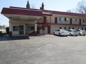 a building with cars parked in a parking lot at Starlite Motor Inn in Absecon