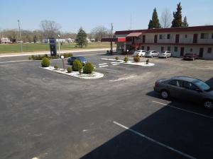 a parking lot with cars parked in front of a building at Starlite Motor Inn in Absecon