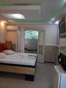 a bedroom with a bed and a window and a television at Motel Morumbi (Adults Only) in Taboão da Serra