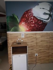 a large picture of a giant strawberry on a wall at Motel Morumbi (Adults Only) in Taboão da Serra