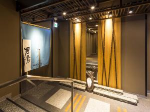 a stage in a room with yellow curtains at APA Hotel & Resort Nishishinjuku-Gochome-Eki Tower in Tokyo