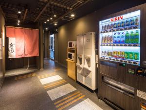a room with a large television and a vending machine at APA Hotel & Resort Nishishinjuku-Gochome-Eki Tower in Tokyo
