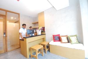 a man standing at a counter in a hotel room at DBeds Kuta Beach By Destiny Hospitality in Kuta