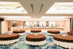 a large room with round tables in the middle at Hotel JAL City Naha in Naha